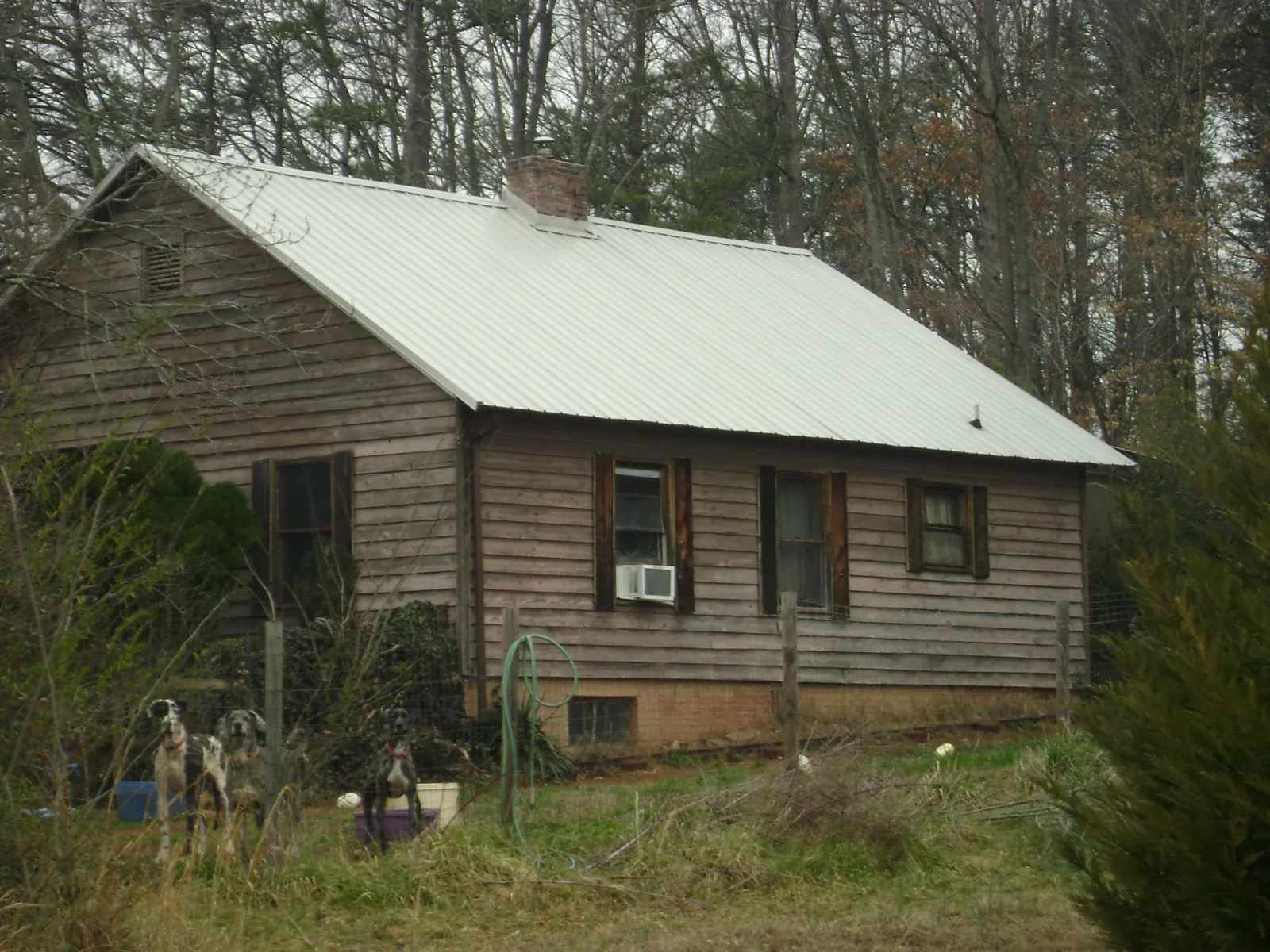White metal roof on an old wood sided farmhouse, from a Metal Roof Installation job in Bridgeton